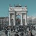 A bustling scene at Arco della Pace in Milan, capturing diverse people under a clear sky.